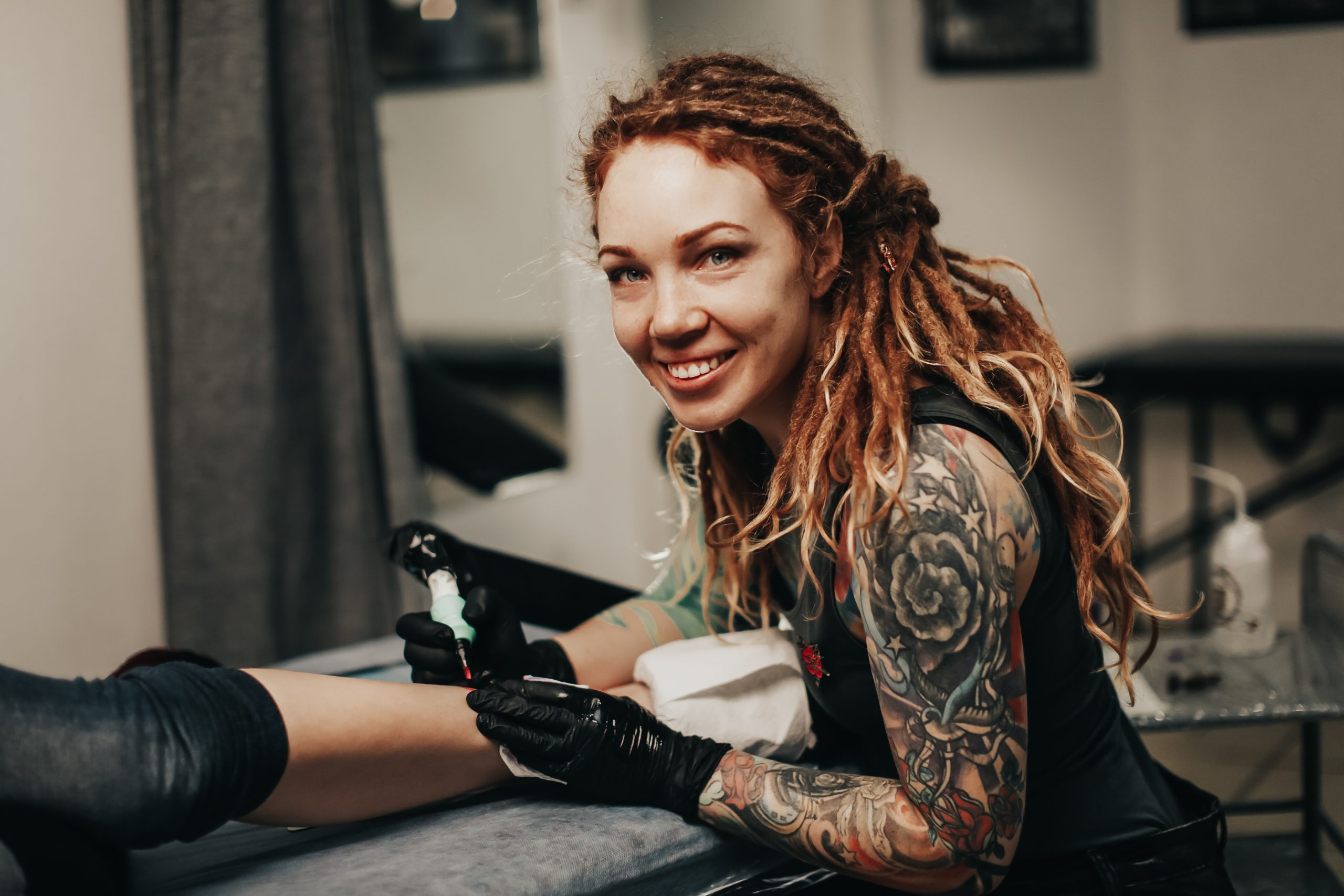 tattoo studio, tattoo artist, custom tattoos, body art, tattoo parlor, ink, tattoo design Tattoo studio with artist creating custom tattoos for clients in a professional setting.